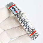 Wristwatch bracelet with red label and polished steel links, angled view