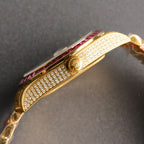 Gold-tone Rolex wristwatch side view with sparkling bezel and gem-set bracelet.