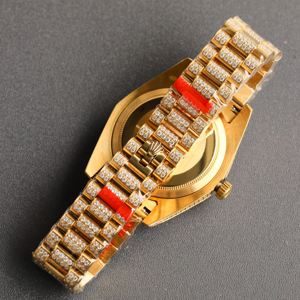 Rolex gold watch bracelet with diamond links and red gemstone center bars