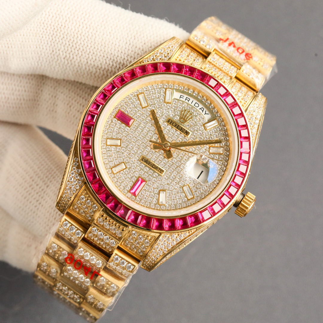 Gold-tone Rolex wristwatch face detail with red bezel, diamond hour markers, and bracelet.