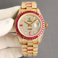 Gold-tone Rolex wristwatch with diamond bezel, red accents, and gemmed bracelet.