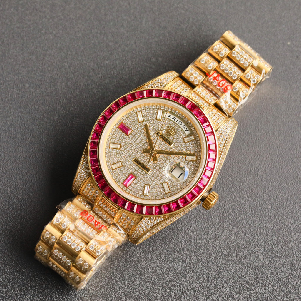 Gold-tone Rolex wristwatch angled view with red bezel and diamond-studded bracelet.