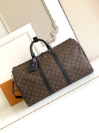 Louis Vuitton monogram duffel bag with black top handles and leather trim