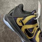 Basketball sneaker quarter view with gold logos on dark purple and black upper