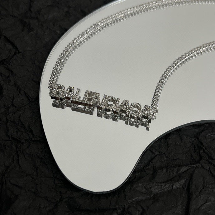 Silver Balenciaga logo pendant necklace with rhinestone-like letters