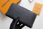 Textured dark leather wallet with front flap fold and visible zipper edge