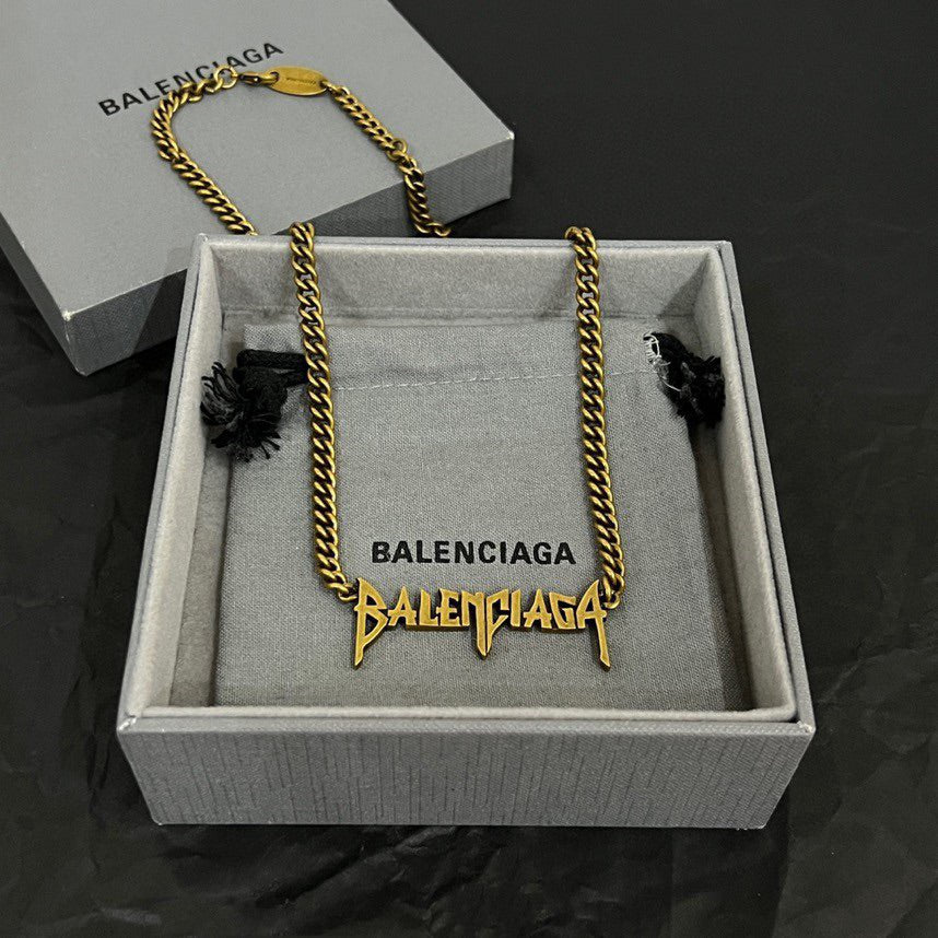Balenciaga gold chain necklace in gift box with branded tag and small flower details