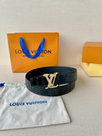 Dark blue croc leather belt with gold-tone LV buckle, styled on a pouch