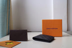 Dark checkered Louis Vuitton wallet lying flat on its side
