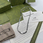Silver-tone chain necklace with round pendant and lobster clasp