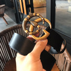 Black leather belt with gold-tone buckle loop and ring detail