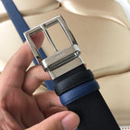 Prada logo on silver buckle of two-tone belt, textured black strap with blue edge