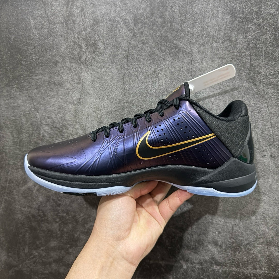 Basketball sneaker in dark purple with gold swoosh, black details, light blue sole
