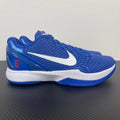 Blue Nike basketball sneaker with white swoosh and white midsole trim