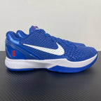 Blue Nike basketball sneaker with white swoosh and white midsole trim