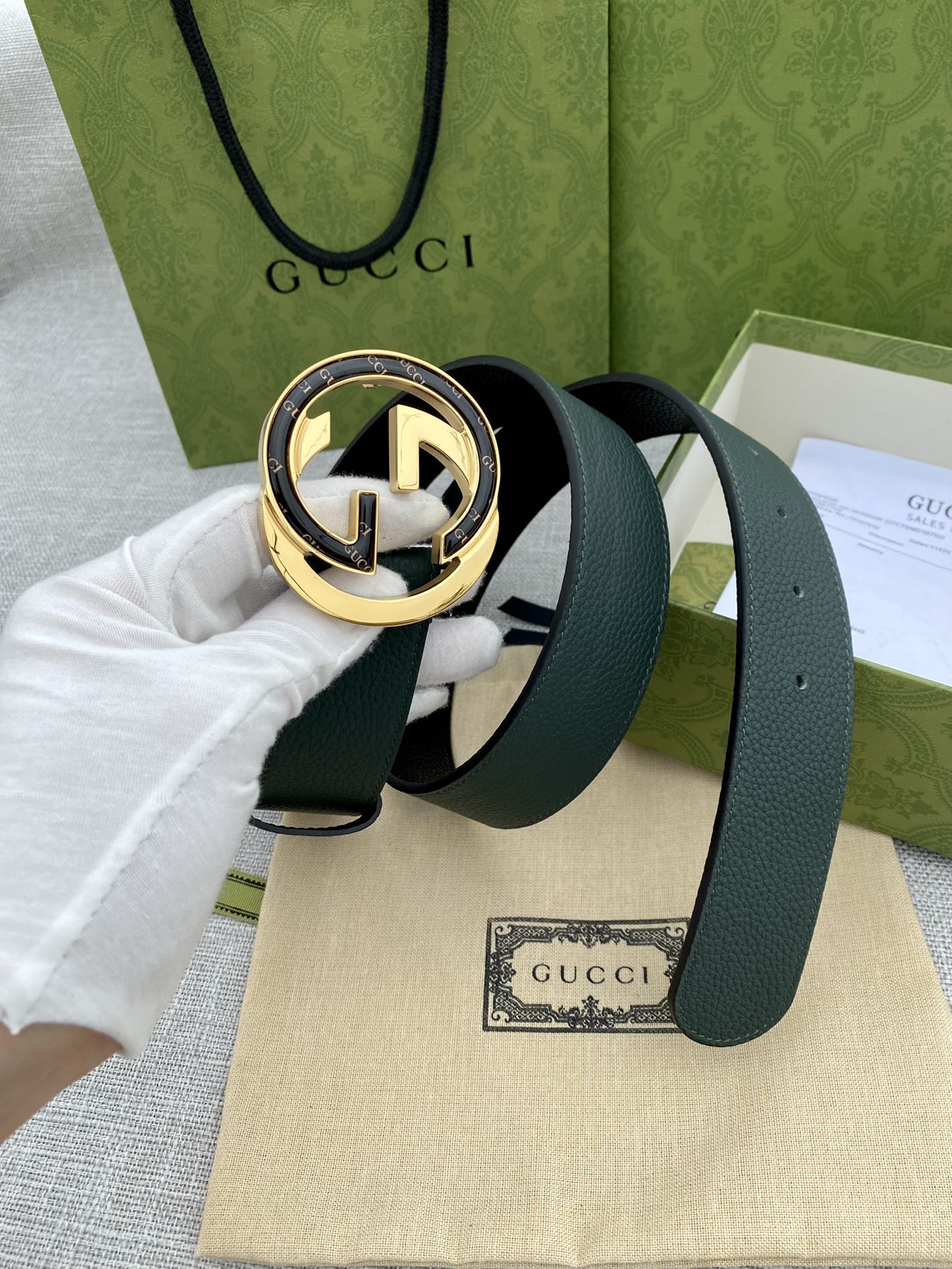 Gucci belt dark green strap with round GG logo buckle in gold and silver
