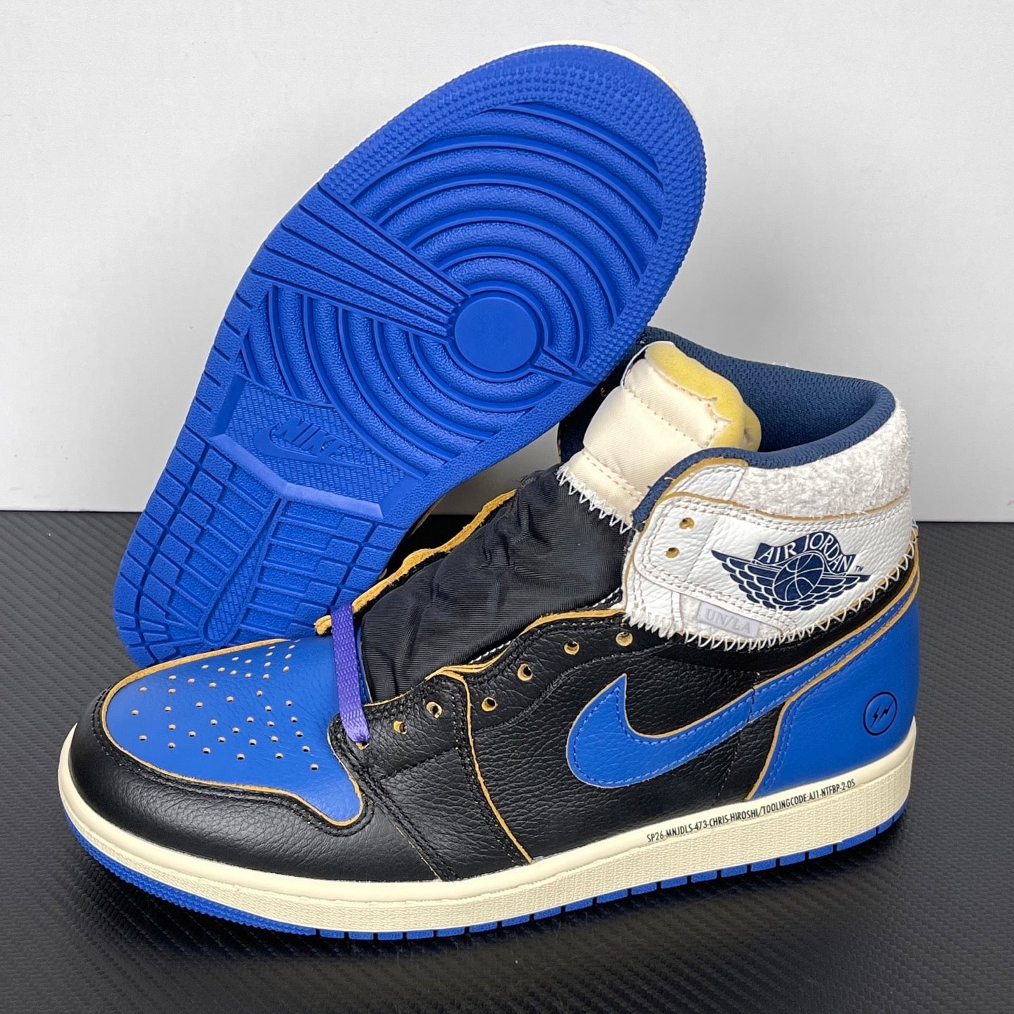 High-top sneakers on outsole: black and blue leather upper with white collar panel, cream midsole