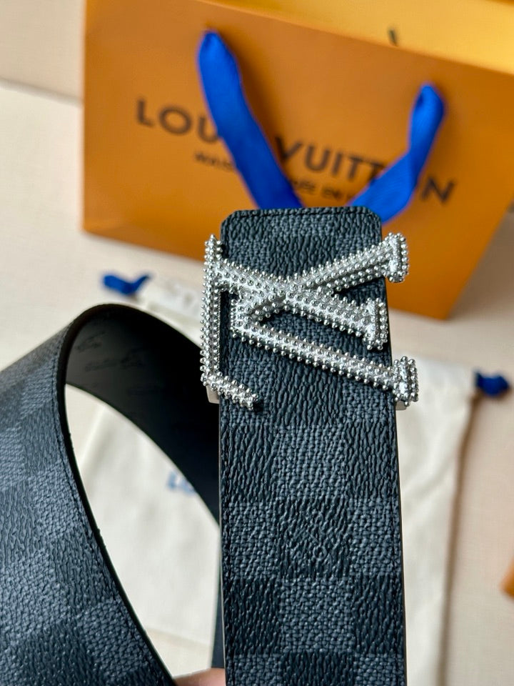 Belt buckle close-up: dark leather strap with silver-toned diamond-studded LV buckle