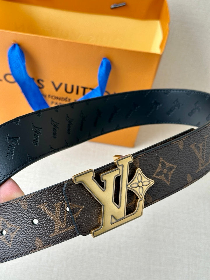 Louis Vuitton monogram belt close-up, showing dark strap and gold logo buckle