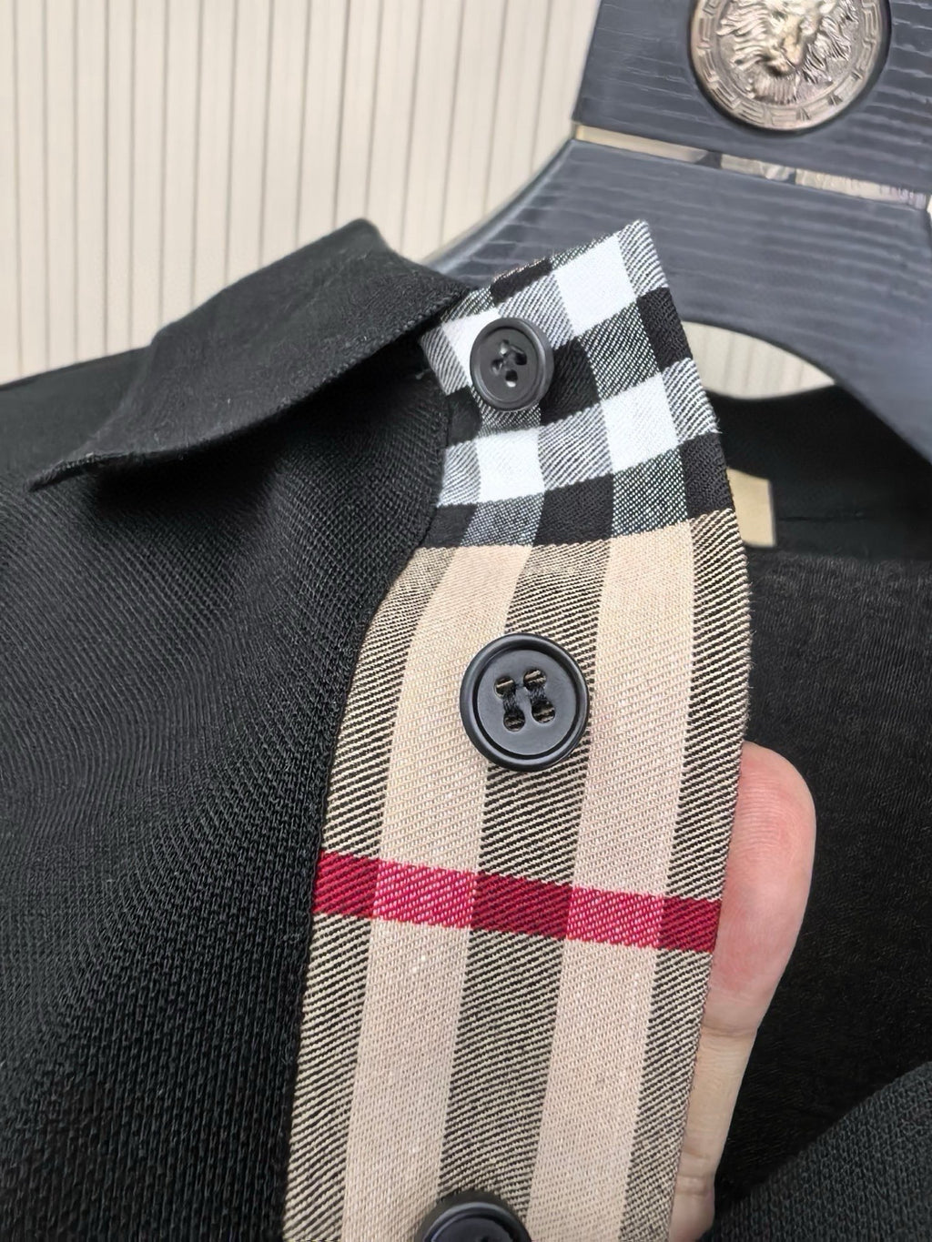 Burberry polo shirt detail, check inner placket and buttons on dark navy