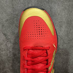 Red basketball shoe toe and lace panel with gold trim and perforations
