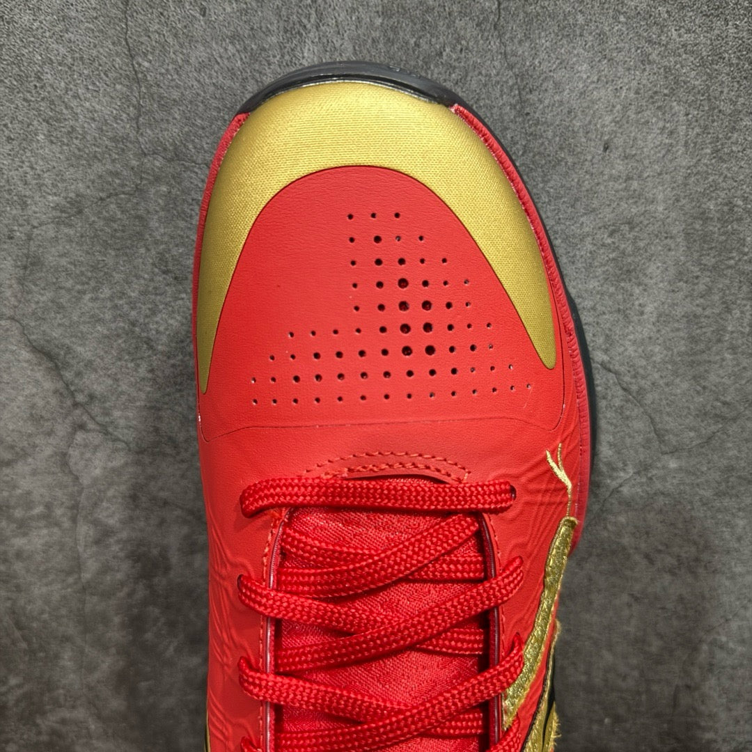 Red basketball shoe toe and lace panel with gold trim and perforations