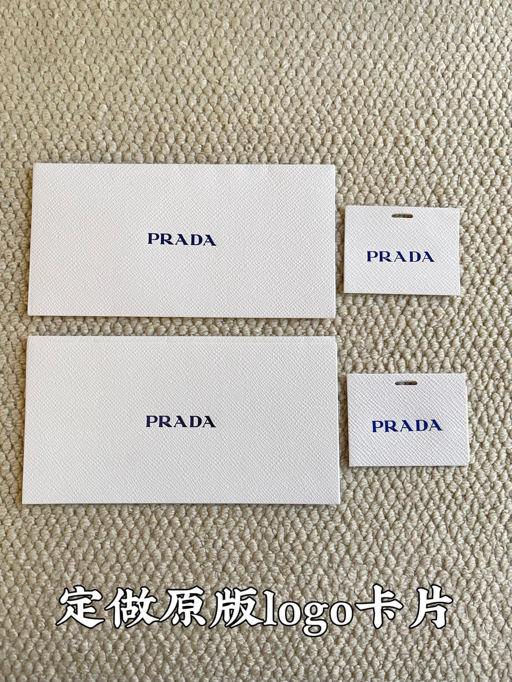 Prada logo fabric cards and small tag cards in white packaging