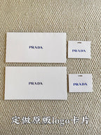 Prada logo fabric cards and small tag cards in white packaging