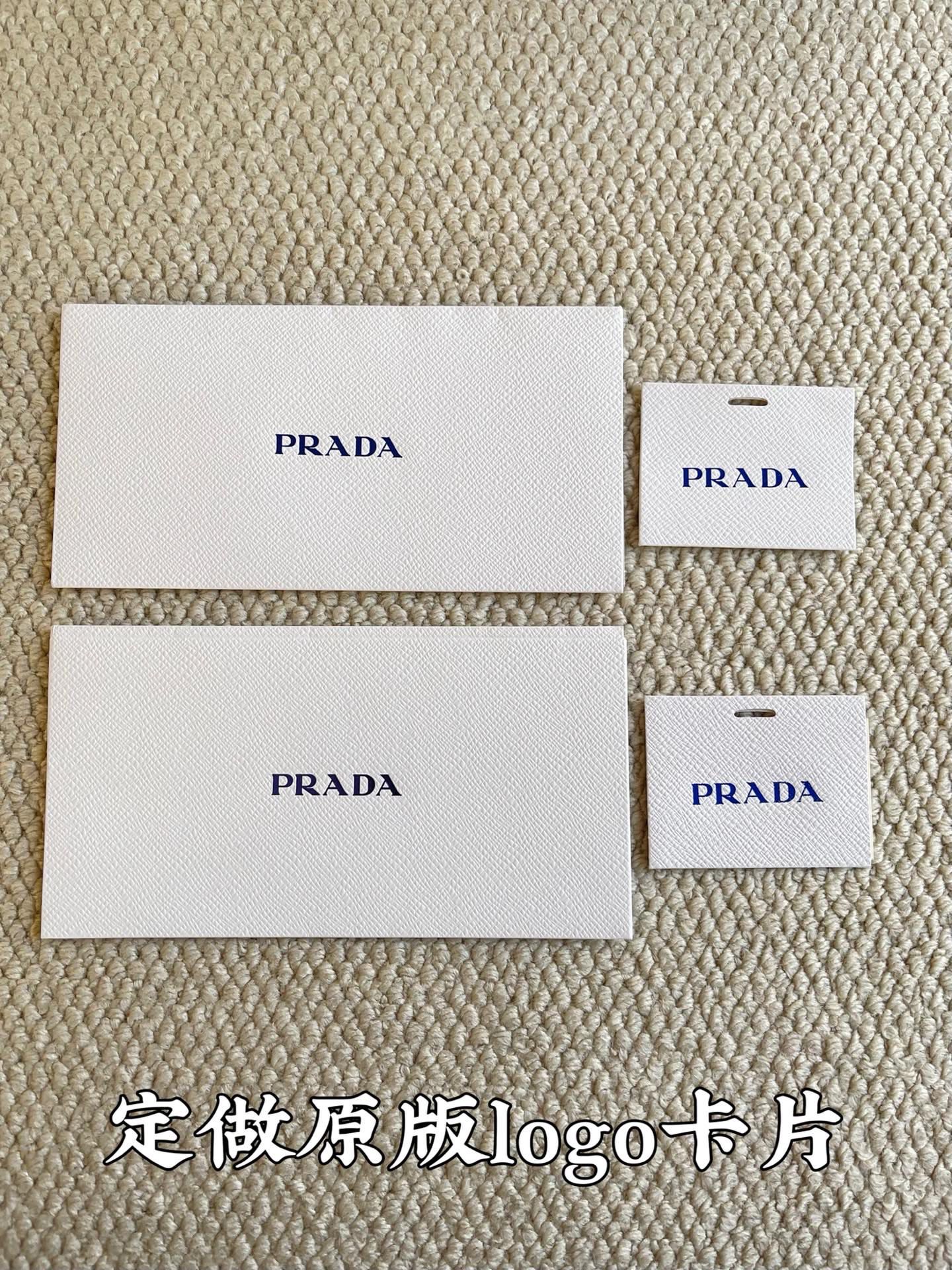 Prada logo fabric cards and small tag cards in white packaging