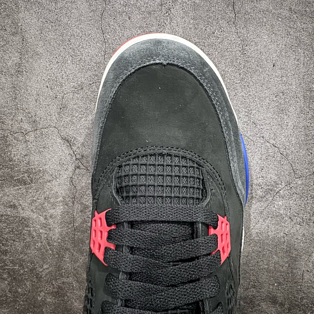 Black sneaker toe with textured grid panel, red lace accents, and blue lining edge
