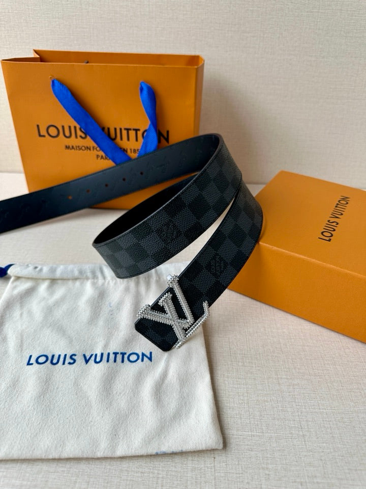Belt with dark checkered strap and silver-toned LV buckle, shown with protective pouch