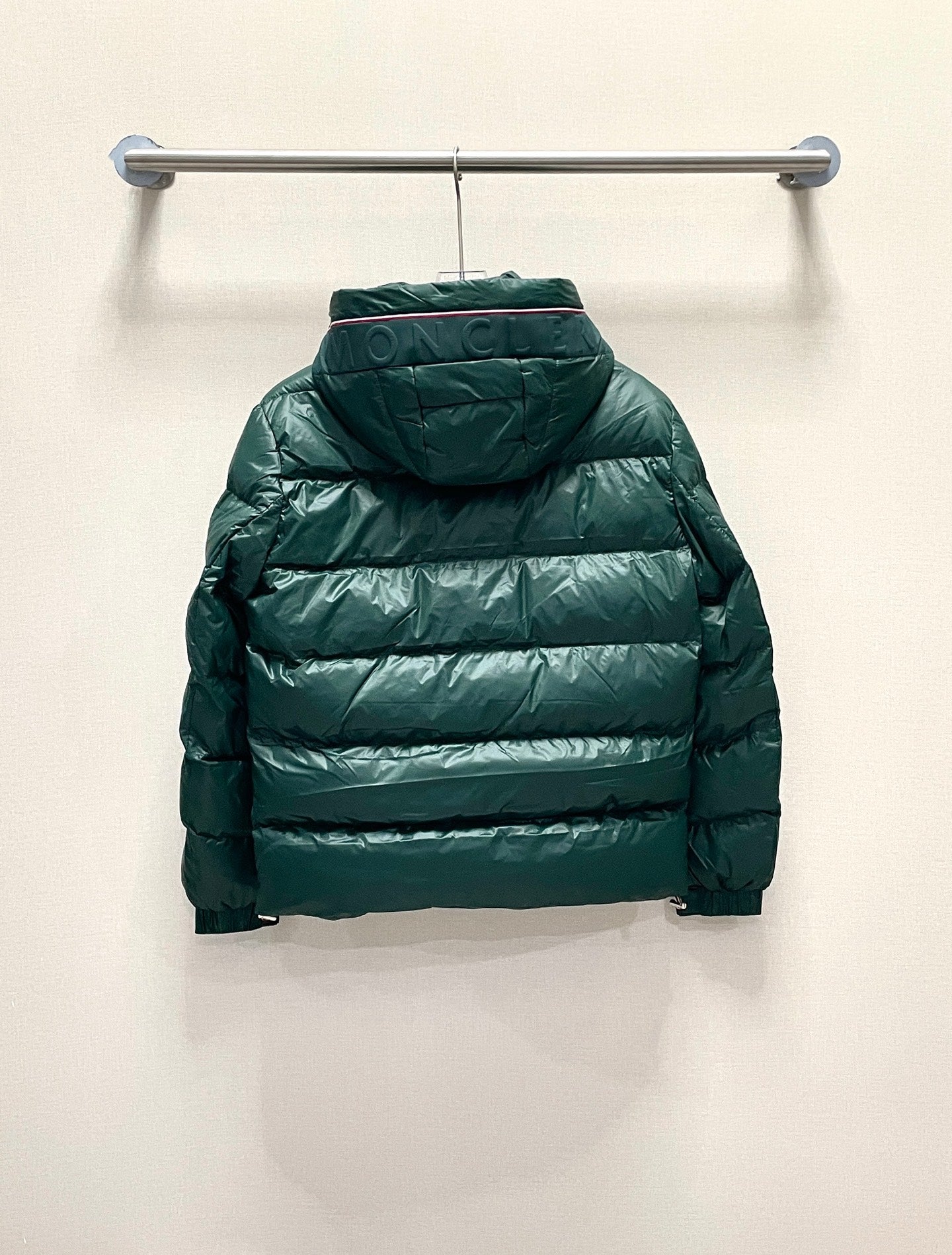Back view hooded puffer jacket, dark green, long sleeves, quilted panels