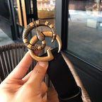 Gucci belt in black leather with gold-tone ornate interlocking buckle