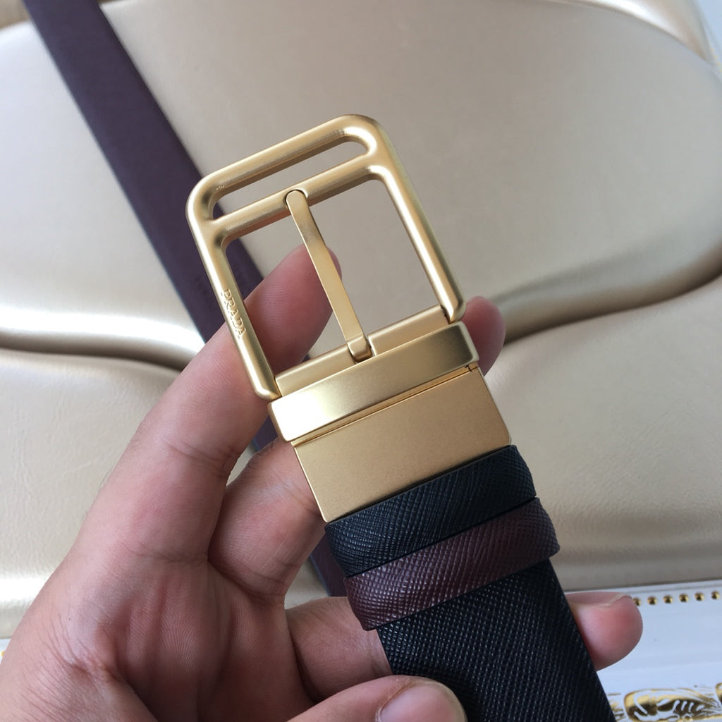 Leather belt buckle view with gold-tone frame on dark blue strap