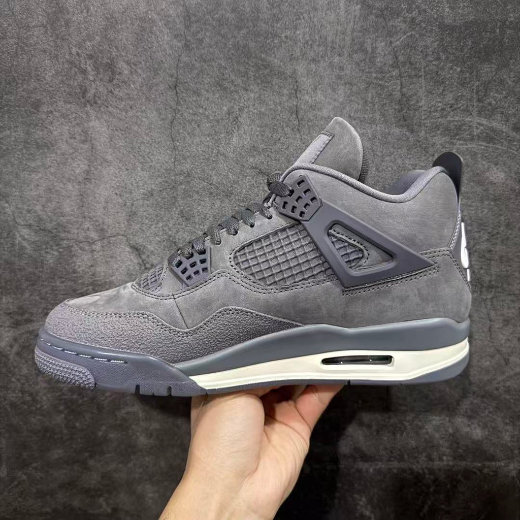 Gray suede Air Jordan 4-style sneaker side view with mesh quarter and lace-up