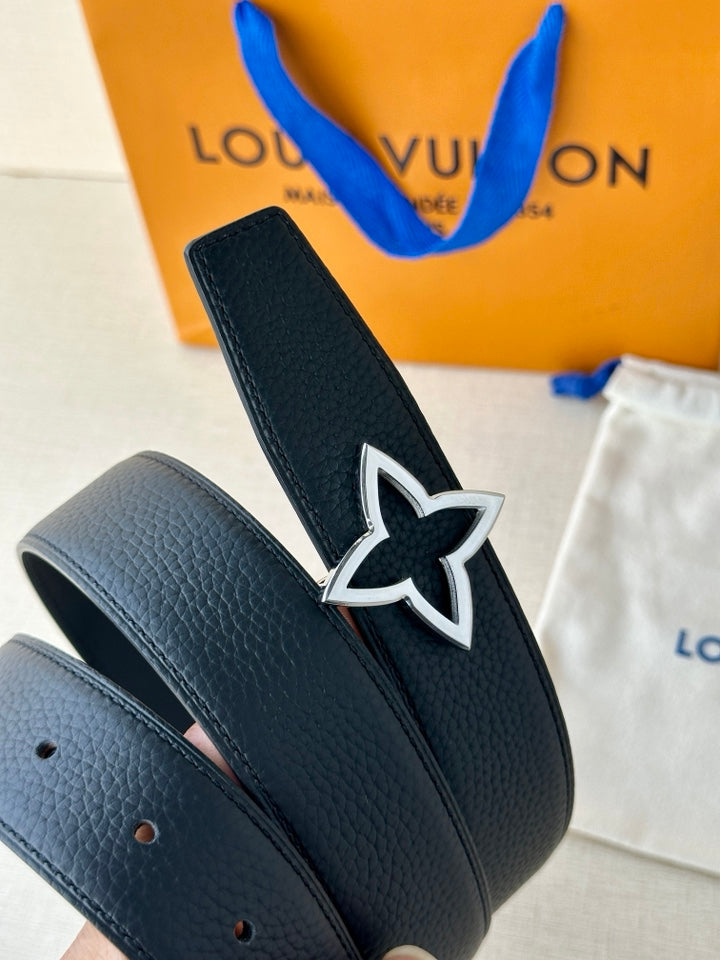 Star emblem buckle on navy pebbled leather belt with punched hole tabs