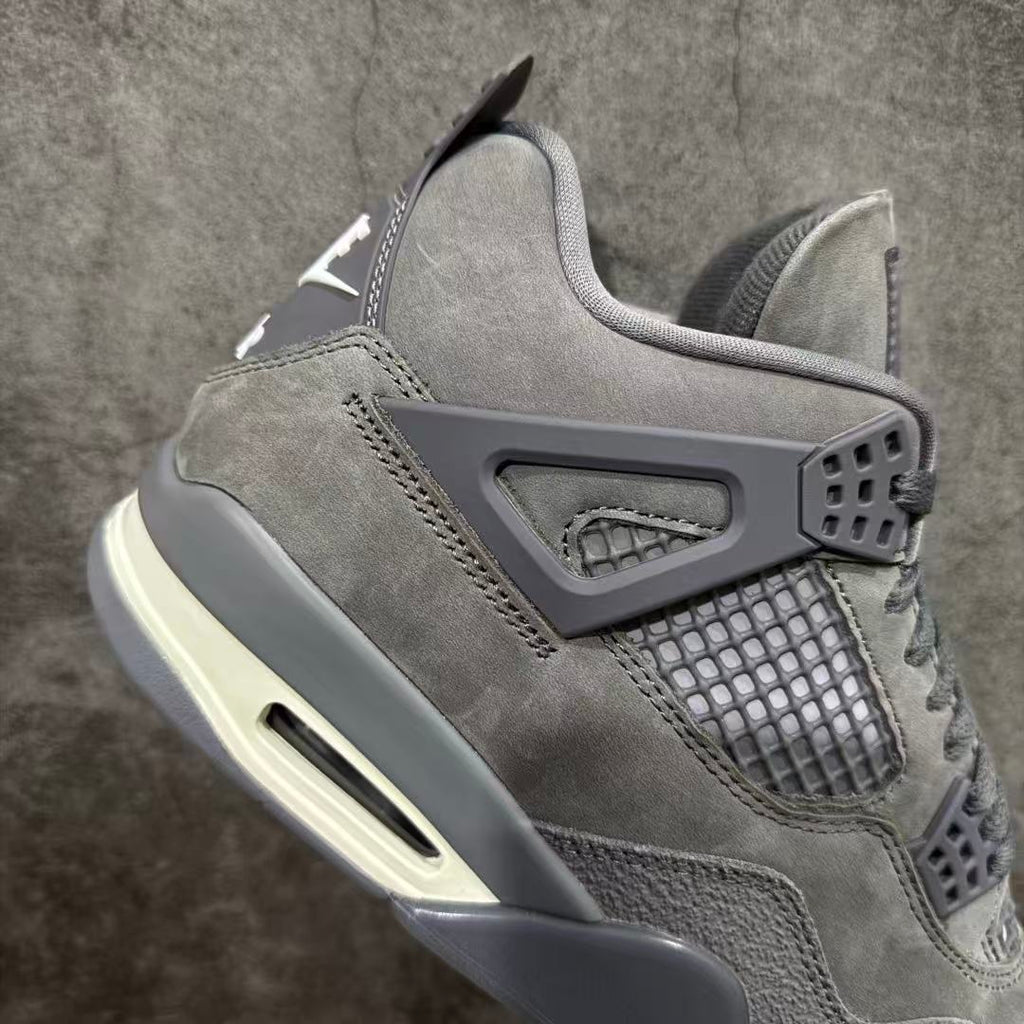 Gray suede sneaker side with mesh window, heel pull tab, and air unit