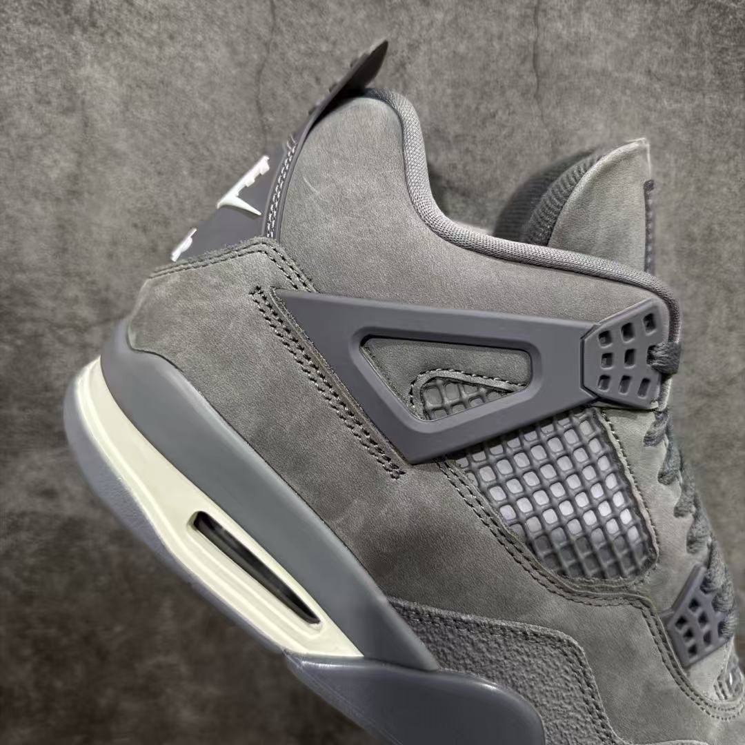 Gray suede sneaker side with mesh window, heel pull tab, and air unit