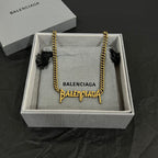 Gold Balenciaga logo necklace with twisted chain in gift box, fabric lining