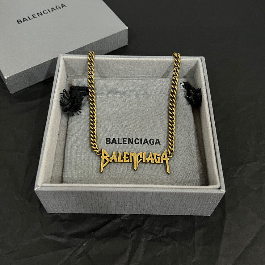 Gold Balenciaga logo necklace with twisted chain in gift box, fabric lining