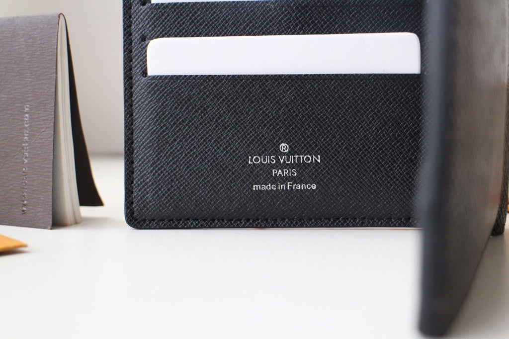 Louis Vuitton small black textured leather card pouch with LV and made in France stamp