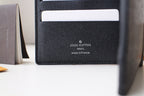 Louis Vuitton small black textured leather card pouch with LV and made in France stamp