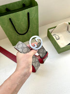 Gucci GG canvas belt with silver G buckle and red leather strap