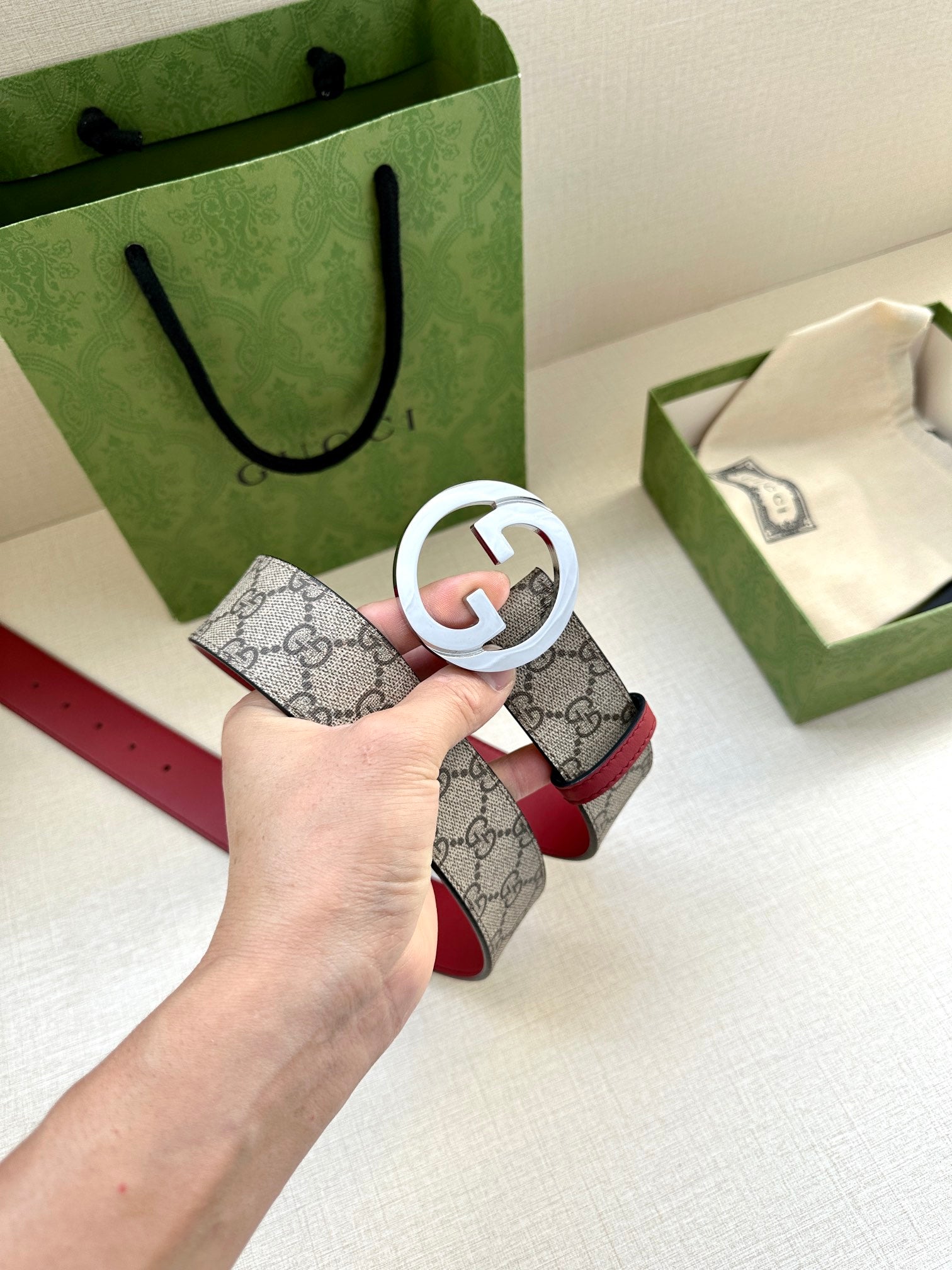 Gucci GG canvas belt with silver G buckle and red leather strap