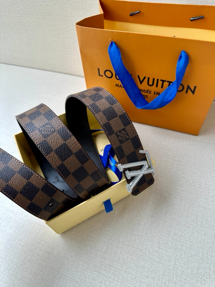 Louis Vuitton belt with Damier check pattern, silver V buckle, folded on box