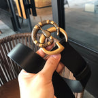 Black leather belt with gold-tone buckle and long loop clasp