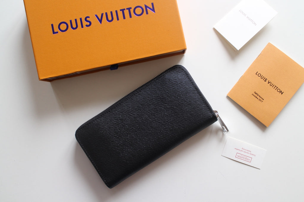 Louis Vuitton small black textured leather zip bag with metal zipper pull