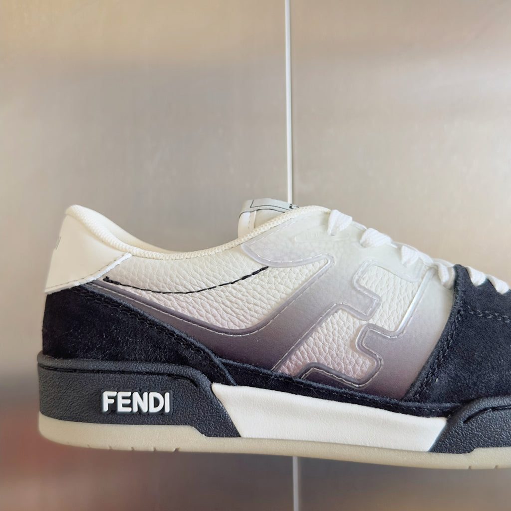 Low-top sneaker close-up: white leather with black side panel, tonal logo details