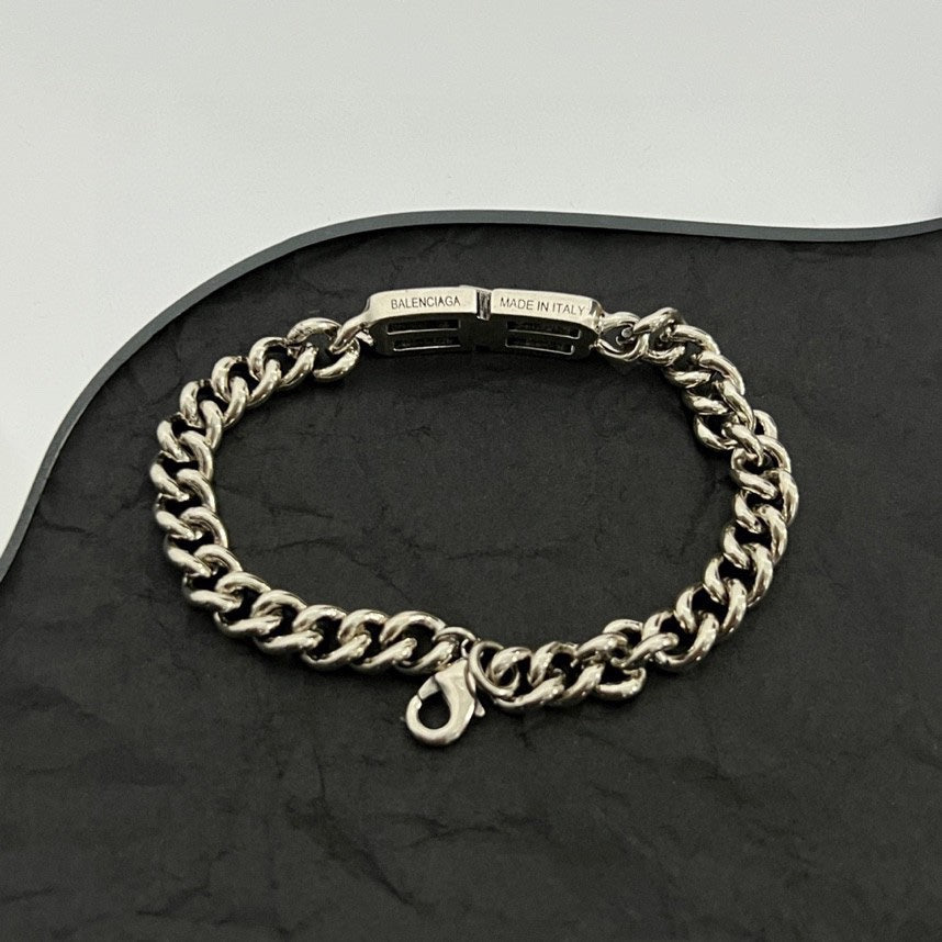 Silver-tone chain bracelet with clasp and engraved tag reading BALENCIAGA