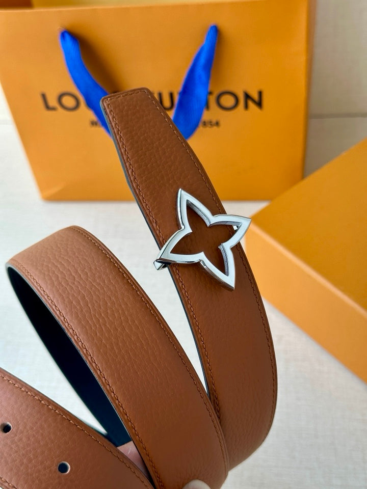 Tan belt with textured finish and silver star buckle with dark navy outline